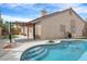 Inviting pool with a Baja step entry, complemented by a pergola-covered patio, perfect for outdoor enjoyment at 8912 Galena Crossing St, Las Vegas, NV 89123