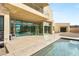 Stunning backyard featuring a modern pool, patio area, and contemporary home design with large glass doors at 9780 Solar Ave, Las Vegas, NV 89149