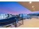 Expansive balcony view showcases the neighborhood's modern architecture and mountain vistas at dusk at 9780 Solar Ave, Las Vegas, NV 89149