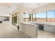 Open floor plan with an entertainment bar featuring stone countertops, a beverage fridge, and backyard views at 9780 Solar Ave, Las Vegas, NV 89149