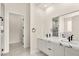 Elegant bathroom with double sinks, sleek white cabinets, and modern black fixtures at 9780 Solar Ave, Las Vegas, NV 89149
