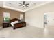 Spacious bedroom with a dark wood bed frame, neutral walls, and a ceiling fan at 9780 Solar Ave, Las Vegas, NV 89149