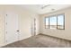 Bedroom featuring neutral carpet, a ceiling fan, and a window at 9780 Solar Ave, Las Vegas, NV 89149