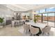 Bright dining area showcases modern design, with a marble table, stylish chairs, and views of the outdoor pool and patio at 9780 Solar Ave, Las Vegas, NV 89149