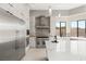 Modern kitchen featuring stainless steel appliances, a marble-topped island, and sleek white cabinetry for a clean and elegant design at 9780 Solar Ave, Las Vegas, NV 89149