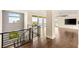 Upper level landing with hardwood floors, modern railings, and views of the surrounding neighborhood at 9780 Solar Ave, Las Vegas, NV 89149