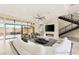 Staged living room with fireplace, stairs, comfortable furniture, and large windows overlooking pool at 9780 Solar Ave, Las Vegas, NV 89149