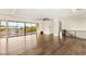 Open floor plan with hardwood floors, large windows, and access to balcony at 9780 Solar Ave, Las Vegas, NV 89149
