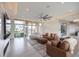 Open-concept living area with large windows, neutral color scheme, and modern furnishings at 9780 Solar Ave, Las Vegas, NV 89149