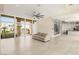 Expansive living room with sleek floors, glass wine storage, and outdoor views at 9780 Solar Ave, Las Vegas, NV 89149