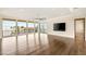 Bright living room with hardwood floors, expansive windows, and access to an outdoor balcony at 9780 Solar Ave, Las Vegas, NV 89149
