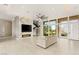 Open-concept living room with fireplace, staircase, and abundant natural light at 9780 Solar Ave, Las Vegas, NV 89149