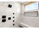 Detailed shot of the luxury shower with marble tiling, stone accents, and a built-in bench at 9780 Solar Ave, Las Vegas, NV 89149