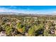 View of a neighborhood with lush landscaping and the Las Vegas skyline in the distance at 1 Quail Run Rd, Henderson, NV 89014