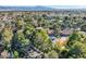 View of a neighborhood with lush landscaping and large homes with tile roofs at 1 Quail Run Rd, Henderson, NV 89014