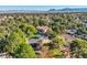 Aerial view of a neighborhood with lush landscaping and a large home with a tile roof at 1 Quail Run Rd, Henderson, NV 89014