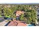 View of a neighborhood with lush landscaping and large homes with tile roofs at 1 Quail Run Rd, Henderson, NV 89014