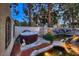 Serene backyard boasts a jacuzzi with a rock water feature and mature trees at 1 Quail Run Rd, Henderson, NV 89014