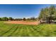 Community baseball field with grassy outfield, surrounded by trees and greenery at 1 Quail Run Rd, Henderson, NV 89014