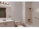 Bright bathroom featuring white vanity, toilet, and a shower over the tub at 1 Quail Run Rd, Henderson, NV 89014