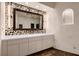 Bathroom vanity area with mosaic tile and chandelier at 1 Quail Run Rd, Henderson, NV 89014