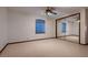 Spacious bedroom featuring neutral carpeting, large window, and mirrored closet at 1 Quail Run Rd, Henderson, NV 89014