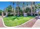 Green Valley Ranch entrance with stone sign, palm trees, lush lawns, and manicured hedges at 1 Quail Run Rd, Henderson, NV 89014