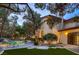 Beautiful home with a custom pool, mature trees, and lush landscaping at 1 Quail Run Rd, Henderson, NV 89014