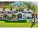 Lush landscaped front yard with water fountain, arched double gate, and a charming two-story home at 1 Quail Run Rd, Henderson, NV 89014
