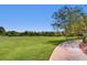Expansive green space in the community with a walking path and mature trees at 1 Quail Run Rd, Henderson, NV 89014