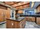 Spacious kitchen with wood cabinets, center island and granite countertops at 1 Quail Run Rd, Henderson, NV 89014