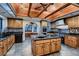Bright kitchen features stone floors, wood cabinets, and a center island with seating at 1 Quail Run Rd, Henderson, NV 89014