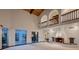 Bright living room features a striking fireplace, high ceilings, and large windows at 1 Quail Run Rd, Henderson, NV 89014