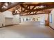 Expansive living room with exposed beam ceiling, neutral carpeting, and open floor plan at 1 Quail Run Rd, Henderson, NV 89014