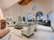 Staged living room shows bright space with large windows, comfortable seating, and stylish decor at 1 Quail Run Rd, Henderson, NV 89014