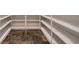 Walk-in pantry with open shelving and dark tile floors at 1 Quail Run Rd, Henderson, NV 89014