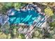 Aerial view of a backyard pool featuring a rock waterfall and lush landscaping at 1 Quail Run Rd, Henderson, NV 89014