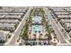 Aerial view of community pool, green space, and car parking surrounded by residential homes and palm trees at 12126 Azure Gate Rd # 1, Las Vegas, NV 89183