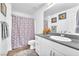 Bright bathroom with a single sink vanity, a grey granite counter, and a shower/tub at 12126 Azure Gate Rd # 1, Las Vegas, NV 89183