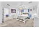 A sunlit bedroom featuring a fluffy white bed, ceiling fan, and adjoining sitting room at 12126 Azure Gate Rd # 1, Las Vegas, NV 89183