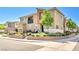 Townhouse showcasing manicured desert landscaping, neutral colors, and a covered balcony for outdoor enjoyment at 12126 Azure Gate Rd # 1, Las Vegas, NV 89183
