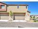 Beige garages with neutral trim under a bright blue sky at 12126 Azure Gate Rd # 1, Las Vegas, NV 89183