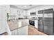Well-lit kitchen offering stainless steel appliances, white cabinets, and solid surface countertops at 12126 Azure Gate Rd # 1, Las Vegas, NV 89183