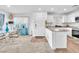 Bright kitchen flows to dining area, with white cabinets, stainless appliances, solid surface countertops at 12126 Azure Gate Rd # 1, Las Vegas, NV 89183