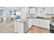 Open-concept kitchen flowing into a dining area with stainless steel appliances and white cabinetry at 12126 Azure Gate Rd # 1, Las Vegas, NV 89183