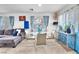 Cozy living room featuring plush sectional sofa, glass table, and dining area with ample natural light at 12126 Azure Gate Rd # 1, Las Vegas, NV 89183