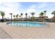 Sparkling community pool offers a refreshing escape, surrounded by comfortable lounge chairs and tall, swaying palm trees at 12126 Azure Gate Rd # 1, Las Vegas, NV 89183