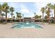 Relaxing community pool with clear water, lounge chairs, umbrellas, palm trees, and changing rooms, inviting residents to unwind at 12126 Azure Gate Rd # 1, Las Vegas, NV 89183