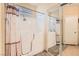 Bathroom featuring a walk-in bathtub and shower combo, with a mirrored sliding door and towel rack at 1252 N Sloan Ln, Las Vegas, NV 89110