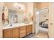 Bathroom featuring a double vanity, large mirror, and access to the toilet and shower area at 1252 N Sloan Ln, Las Vegas, NV 89110